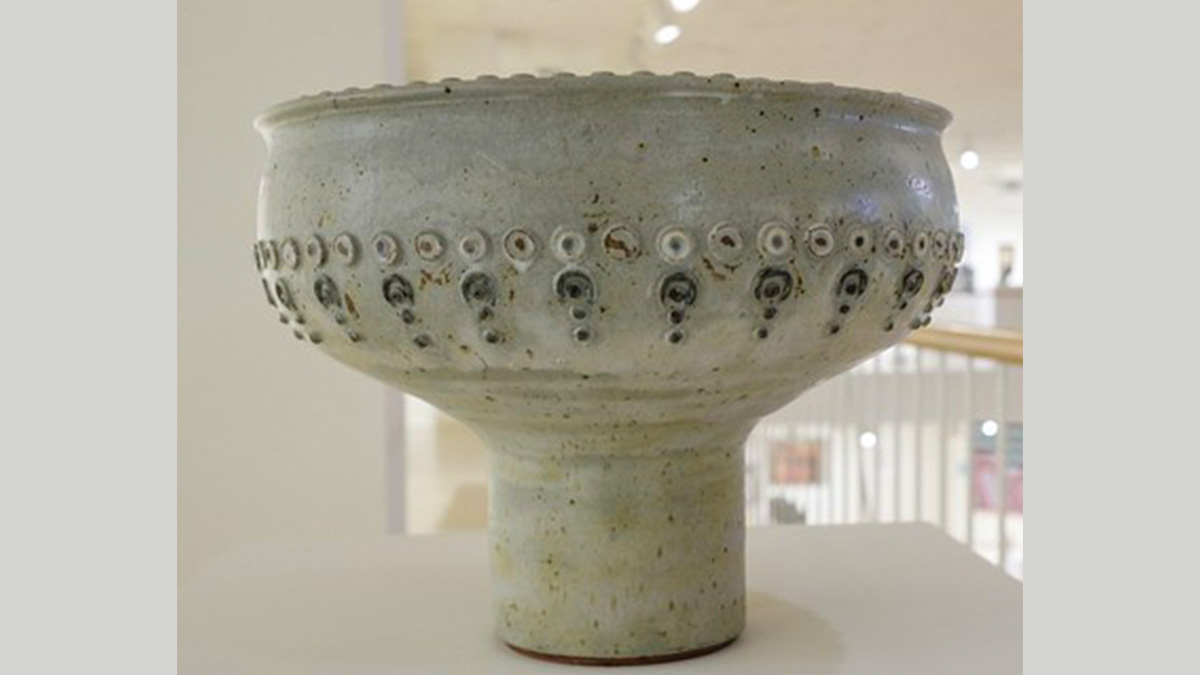 large grey footed stoneware punch bowl with pattern design between the footed-base and the top