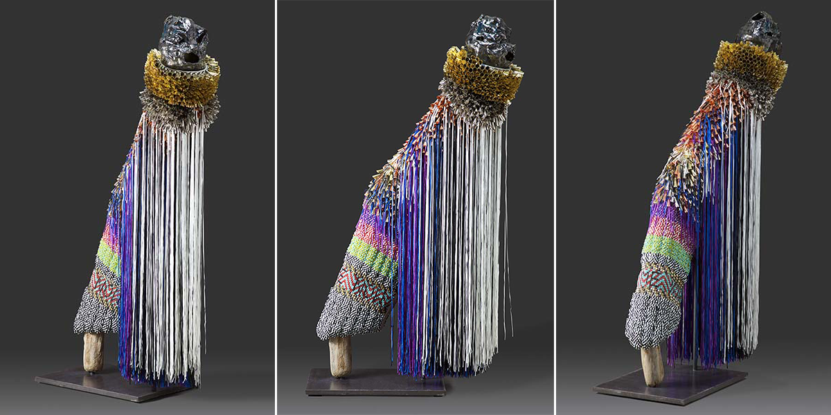 three photographs of a sculpture viewed from front, side, and back, made of Glass beads, copper and tin jingles, steel and brass studs, nylon fringe, and artificial sinew on wool blanket and canvas with poly-fill; glazed ceramic, driftwood and steel support