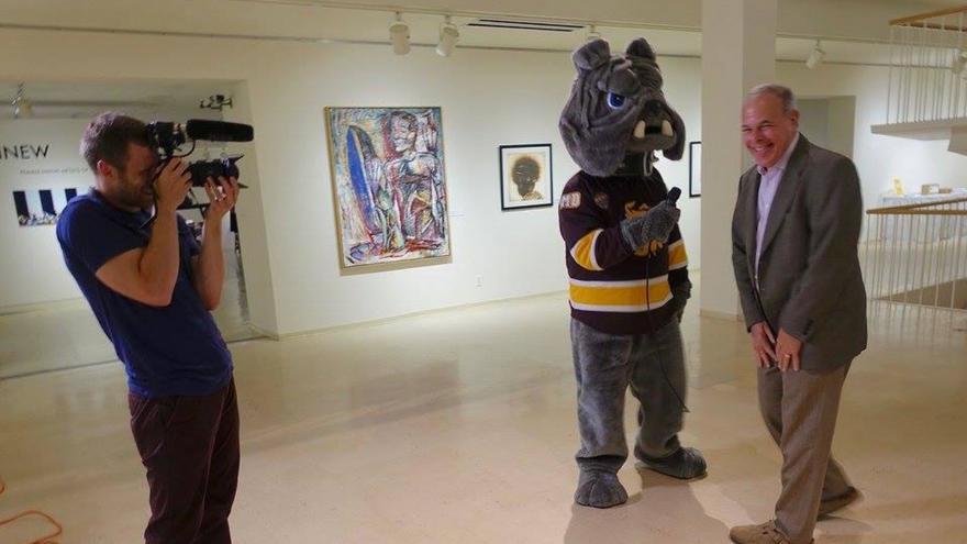 videographer filming UMD bulldog Champ talking to Ken Bloom Tweed Museum director on his retirement