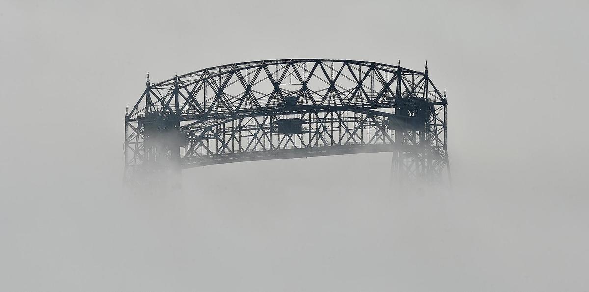 The Duluth aerial lift bridge partially obscured by fog.