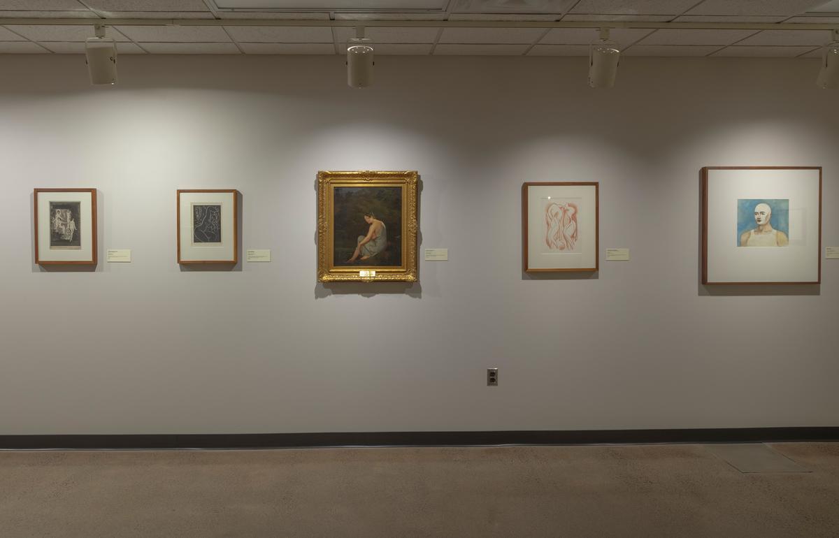 A photo of an exhibit at the Tweed, prints and paintings on a wall.