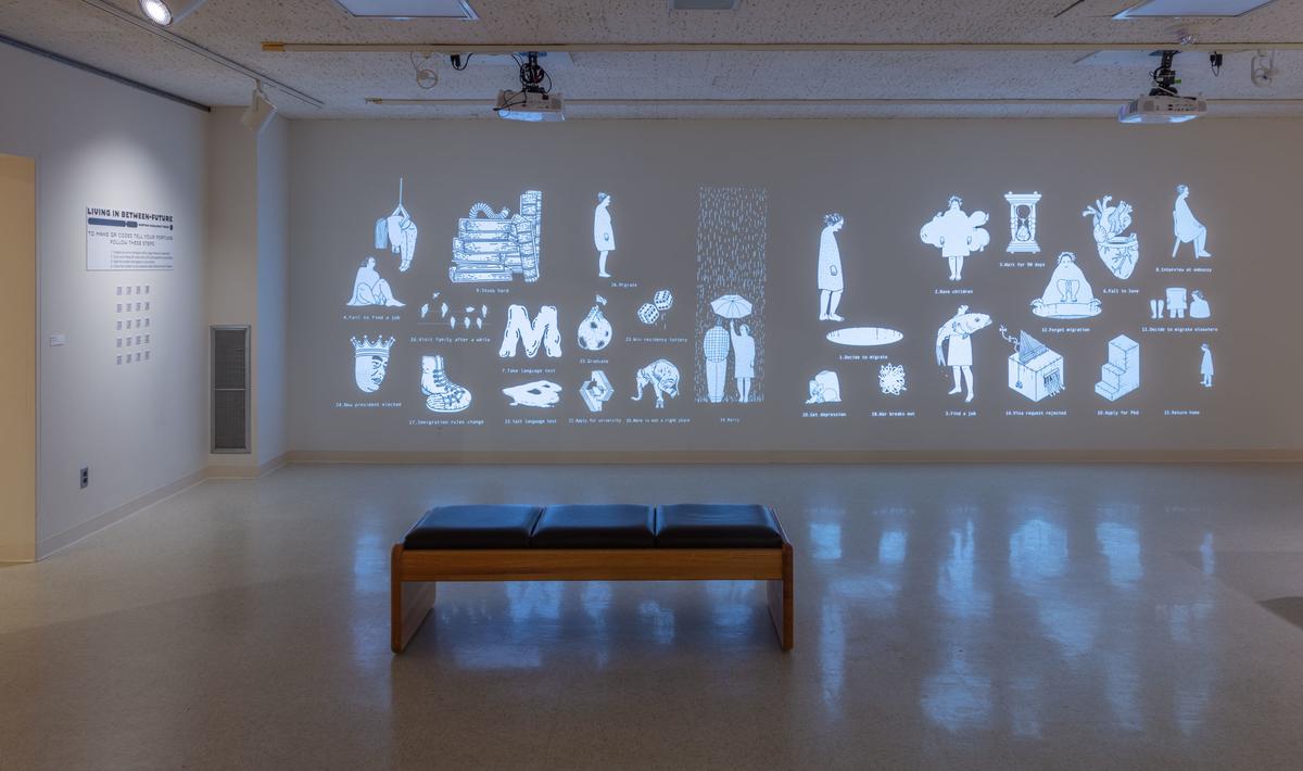 An art gallery with images projected against the far wall.